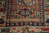 Late 19th century Kazak rug showing geometric patterns and original worn end.