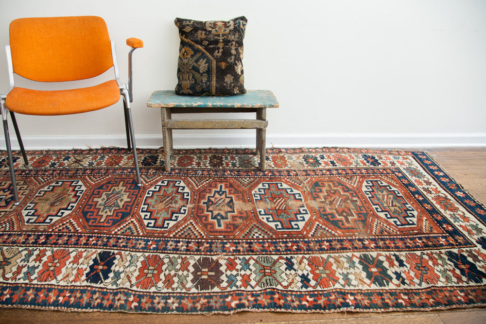 19th century antique Kazak runner, rich geometric patterns in terracotta, indigo, and ivory.