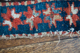 Hand-knotted edge of antique Kazak rug, with geometric design and color-changing weft.