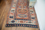 Lower border of the antique Kazak runner with contrasting geometric patterns and aged fringe.