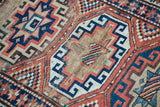 Worn pile of an antique Kazak runner, exposing natural foundation with patterned wefting.