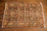 Herati pattern with rusty accents on walnut field of early 20th century tribal rug.