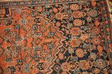 Antique Bijar rug detail: geometric Herati field design in deep red, navy, and light blue.