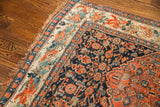 Antique Bijar rug corner with dark herati field, European floral border, and wear.