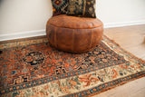 Antique Bijar rug detail showing European-influenced border, herati field, and tattered edge.