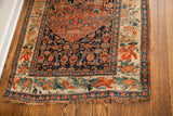 Corner of antique Bijar rug showcasing European floral border with visible fringe wear.