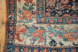 Antique Bijar rug corner showcasing unique Persian field motifs and European rose border.