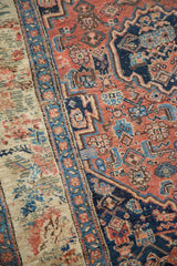 Antique Bijar rug detail: coral red Persian herati field and blue European floral border.