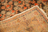 Antique Samarkand rug corner revealing its worn pile, raw fringe, and distinct knotted foundation.