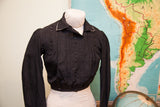Shiny black Edwardian button bodice with subtle woven texture and collar trim.