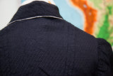 Textured black fabric and white collar detail on the antique Edwardian bodice.