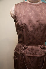 Vintage 60s Asian-inspired dress detail: mauve jacquard leaf pattern and coiled closures.