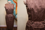 Textured muted plum vintage Asian-inspired dress showing decorative waist closures.
