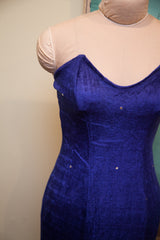 Sapphire blue velvet dress by Betsey Johnson, showcasing rhinestones and pointed bodice.