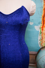 Close-up of sapphire blue velvet prom dress bodice, with pointed shape and rhinestones.
