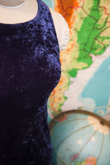 Close-up detail of the deep purple velvet fabric on the vintage dress's bust.