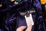 Close-up of the Betsey Johnson designer tag on the vintage deep blue velvet dress.