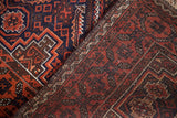 Distinct sections of a Vintage Tribal Belouch rug with deep indigo, madder red, and walnut geometric patterns.