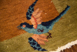 Vibrant blue, teal, and orange flying bird motif on the vintage Chinese Art Deco rug.