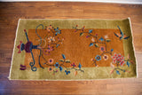 Vibrant Chinese Art Deco rug with gold field, green border, expressive vase, and flowers.