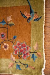 Early 20th century Chinese Art Deco rug corner: blue bird, flowering tendrils, green border.