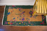 Art Deco Chinese rug with deep gold field, green border, colorful florals, exposed knots.