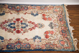 Kerman rug mat border, European-Persian floral design in rose and indigo, showing even pile wear.