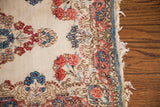 Vintage Kerman floral rug mat detail: tone-on-tone rose, indigo patterns, worn fringe.