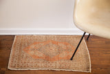 Vintage Persian Tabriz rug's intricate border, rust field, and natural cord selvage.