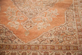Lustrous soft rust pile with intricate patterns of wooden and ivory tones.