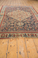 Antique Bijar rug with indigo, coral, saffron floral design, fine weave, and worn fringe.