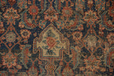Fine weave of an antique Bijar rug, worn to reveal intricate indigo, red, and beige motifs.