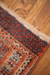Vintage Bokhara rug's geometric elephant footprint guls in terracotta, navy, and ivory.