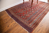 Early 20th century Tekke Bokhara rug's rust red geometric gul pattern with exposed foundation.