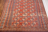 Vintage Tekke Bokhara rug with terracotta guls, navy motifs, and softened original pile.