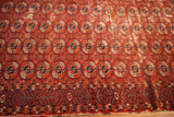 Antique Tekke rug's field of red Bokhara guls, geometric border, and storied pile.
