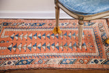 Terracotta vintage Turkish Melas rug with blue geometric triangles and patterned borders.