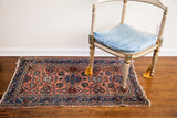 Vintage Persian Hamadan rug, light rose field, indigo border, with detailed palmette patterns.