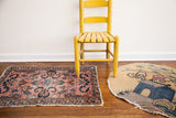 Vintage Persian Lilihan rug with light rose field, cloudband medallion, blue floral vines, tattered edges.