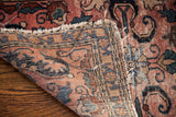 Vintage Persian Lilihan rug corner with tattered fringe, rose field, and blue floral motifs.
