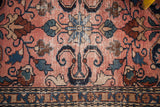 Vintage Persian Lilihan mat, cloudband motif and sprawling floral vines in rose, denim blue.