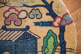 Detail of whimsical Chinese rug with blue cottage, plum clouds, green tree, worn edge.