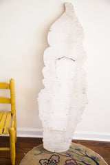 Reverse of the vintage wooden ice cream sign, revealing weathered white wood grain and hanger.