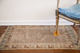 Late 18th-century Antique Turkish rug with an aged ivory field, teal medallion, allover motifs.