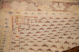 Hand-knotted weave detail of antique Turkish rug, featuring aged ivory and burgundy geometric patterns.
