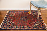 Vintage Red Bijar rug, cherry red field, classic medallion with asymmetric lanterns.