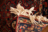 Tightly woven edge and slightly worn fringe of a vintage Persian Bijar rug.