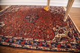 Intricate border and corner design of vintage Bijar rug with cherry red, blue, and ivory.