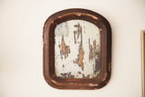 Distressed shabby mirror with chippy dark wood frame and mottled silvering.