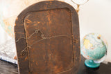 Worn wooden back panel of the antique distressed mirror, with twisted wire hanger.